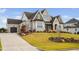 Charming two-story home with a driveway leading to a garage and a well-maintained lawn at 1804 Clifton Pines Dr, Cary, NC 27519