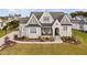 Beautifully landscaped two-story home with a welcoming front porch and manicured lawn at 1804 Clifton Pines Dr, Cary, NC 27519