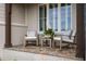 Inviting front porch with rocking chairs, a table with plants, and large windows at 1804 Clifton Pines Dr, Cary, NC 27519