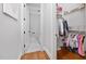 Bright hallway view leading to a bathroom and closet, showcasing hardwood floors at 1804 Clifton Pines Dr, Cary, NC 27519