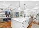 Open concept kitchen with island, stainless appliances, and views to the living area at 1804 Clifton Pines Dr, Cary, NC 27519