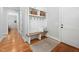 Inviting mudroom area features a built-in bench, storage baskets, and classic hardwood flooring at 1804 Clifton Pines Dr, Cary, NC 27519