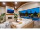 Cozy covered patio features a fireplace, TV, and seamless access to a pool with a waterfall at 1804 Clifton Pines Dr, Cary, NC 27519