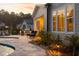 The patio has a stone walkway, landscape lighting, and a built-in grill that complements the home's exterior design at 1804 Clifton Pines Dr, Cary, NC 27519