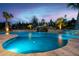 Backyard pool featuring stone coping, a rock waterfall feature, and professional landscaping, perfect for relaxation and recreation at 1804 Clifton Pines Dr, Cary, NC 27519