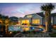 This pool is a backyard paradise with lush tropical landscaping, stone accents, and lighting for nighttime enjoyment at 1804 Clifton Pines Dr, Cary, NC 27519