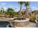 Outdoor spa with waterfall and stone surround with tropical landscaping in backyard at 1804 Clifton Pines Dr, Cary, NC 27519