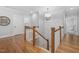 Staircase with hardwood floors and white railings leading to the second floor at 1804 Clifton Pines Dr, Cary, NC 27519