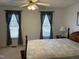 Serene bedroom with two large windows, ceiling fan, and neutral decor at 1811 Kelly Glen Dr, Apex, NC 27502