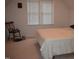 Bedroom featuring a window with blinds, light carpet, and a chair at 1811 Kelly Glen Dr, Apex, NC 27502
