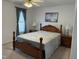 Relaxing bedroom showcasing a wooden bed frame, coordinating nightstands, and soft window treatments at 1811 Kelly Glen Dr, Apex, NC 27502