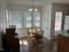 Bright breakfast nook featuring a round table, wood chairs, and natural light from the surrounding windows at 1811 Kelly Glen Dr, Apex, NC 27502