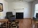 The bright living room has hardwood floors, a traditional fireplace, neutral walls and an overhead light and fan at 1811 Kelly Glen Dr, Apex, NC 27502