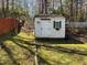 Charming shed with a classic design, a small window and green trim, nestled in a grassy backyard at 1811 Kelly Glen Dr, Apex, NC 27502