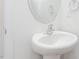Bathroom featuring white pedestal sink, chrome fixtures, and a bright, clean aesthetic at 1912 Frost Dr, Haw River, NC 27258