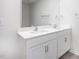Bathroom featuring double vanity sinks, white cabinets, and a large mirror at 1912 Frost Dr, Haw River, NC 27258