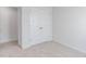 Bright bedroom featuring neutral carpet, white walls and trim, and a double-door closet at 1912 Frost Dr, Haw River, NC 27258