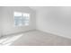 Spacious bedroom with neutral carpet, a large window, and ample natural light at 1912 Frost Dr, Haw River, NC 27258