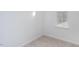Bright bedroom with neutral carpet, window view, and fresh paint at 1912 Frost Dr, Haw River, NC 27258