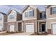 Attractive townhouse showcasing a stone and siding exterior with a one-car garage at 1912 Frost Dr, Haw River, NC 27258