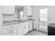 Stylish kitchen featuring white cabinetry, granite counters, and stainless steel dishwasher at 1912 Frost Dr, Haw River, NC 27258