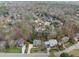 An aerial view showcases a neighborhood with mature trees and well-maintained lawns at 204 Brittany Pl, Cary, NC 27511