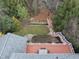 Aerial view of a lush backyard featuring a patio, bridge, and well maintained deck at 204 Brittany Pl, Cary, NC 27511
