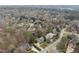 Elevated neighborhood view showing home exteriors, tree coverage, and street layout from above at 204 Brittany Pl, Cary, NC 27511