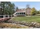 Large backyard with a creek, bridge, and multi-level deck and patio areas at 204 Brittany Pl, Cary, NC 27511