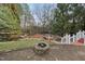 Backyard featuring a stone firepit and a small bridge over a creek in the yard at 204 Brittany Pl, Cary, NC 27511
