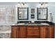 Bathroom with a double vanity with black granite countertops and wood cabinets at 204 Brittany Pl, Cary, NC 27511