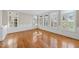Dining room featuring hardwood floors, wainscoting, modern light fixture and natural light at 204 Brittany Pl, Cary, NC 27511