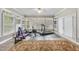 Home exercise room features bright, natural light with shuttered windows and a variety of equipment at 204 Brittany Pl, Cary, NC 27511