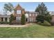 Beautiful two-story brick home with a well-manicured lawn and mature trees at 204 Brittany Pl, Cary, NC 27511