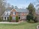 Traditional brick home with well-maintained lawn and mature greenery creating inviting curb appeal at 204 Brittany Pl, Cary, NC 27511