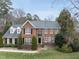 Traditional red brick home featuring a manicured lawn, classic shutters, and a welcoming front entrance at 204 Brittany Pl, Cary, NC 27511