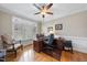 Bright home office features a wooden desk with built-in drawers, a ceiling fan, and natural light from shuttered windows at 204 Brittany Pl, Cary, NC 27511