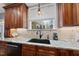 Kitchen sink area with granite countertops, a window, and wooden cabinets at 204 Brittany Pl, Cary, NC 27511
