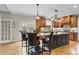 Gourmet kitchen with center island, custom cabinets, granite counters, and stainless steel appliances at 204 Brittany Pl, Cary, NC 27511