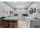 Eat-in kitchen area with grey cabinets, wood stools, and green countertops at 204 Brittany Pl, Cary, NC 27511