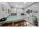 An eat-in kitchen area featuring a breakfast bar with stools and grey cabinets at 204 Brittany Pl, Cary, NC 27511