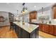 Open kitchen featuring a large center island, hardwood floors, and pendant lighting at 204 Brittany Pl, Cary, NC 27511