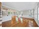 Bright, spacious living room featuring hardwood floors, wainscoting, and abundant natural light at 204 Brittany Pl, Cary, NC 27511