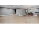 A expansive living room space with wood flooring, gray walls and entry to the kitchen at 204 Brittany Pl, Cary, NC 27511