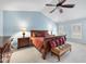 Vaulted main bedroom features a large bed with upholstered bench and plenty of natural light at 204 Brittany Pl, Cary, NC 27511