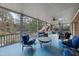 Spacious screened porch features comfortable seating, ceiling fans and a view of the lush backyard at 204 Brittany Pl, Cary, NC 27511