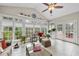 Sunroom featuring tiled floors, vaulted ceilings, ample windows, and cozy seating arrangements at 204 Brittany Pl, Cary, NC 27511