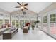 Light-filled sunroom with many windows, vaulted ceilings, and comfortable wicker furniture at 204 Brittany Pl, Cary, NC 27511