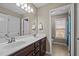 Bathroom featuring double sinks, mirrors, and ceramic floors at 2059 Glenkirk Dr, Burlington, NC 27215