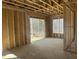 Spacious garage framed walls with natural light and a rear view of backyard, ready for customization at 211 Meadow Walk Dr, Fuquay Varina, NC 27526